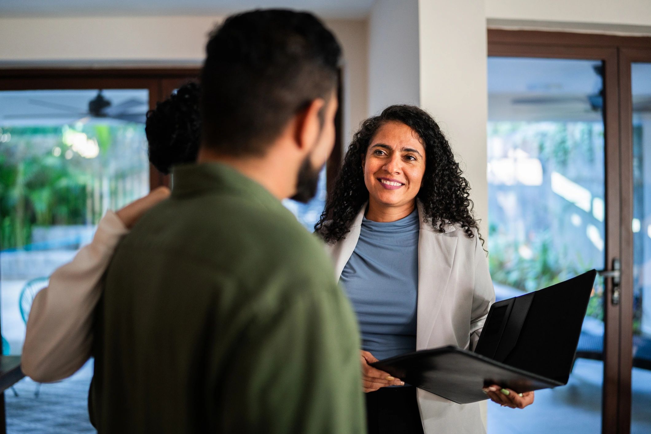 Real estate agent reviewing documents with clients