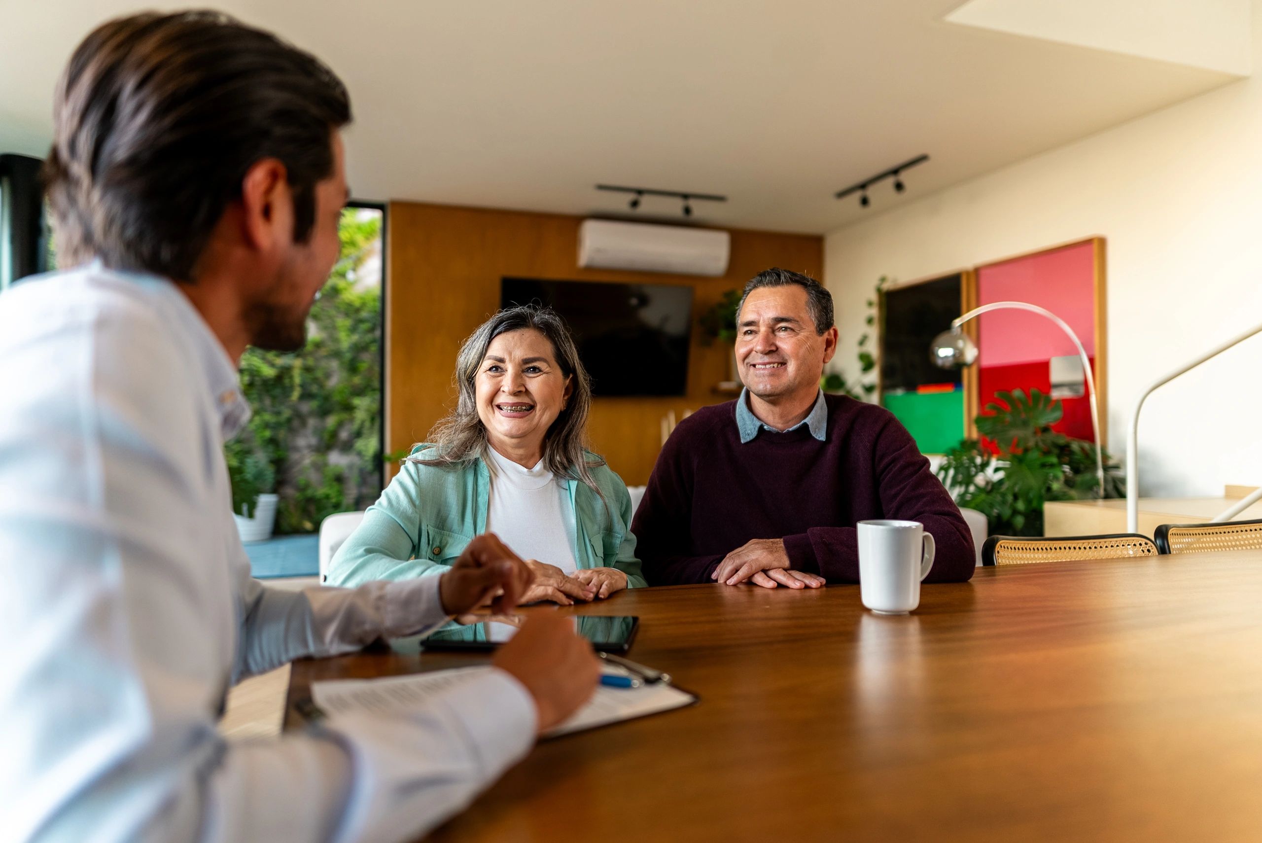 Real estate agent speaking with a couple at a home